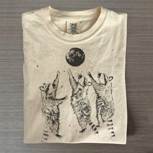 Three Raccoons Playing Under Moonlight T-Shirt